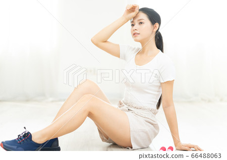 Beautiful woman doing exercise at home 66488063