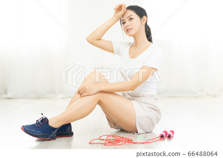 Beautiful woman doing exercise at home Beautiful woman doing exercise at home 66488064
