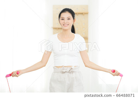 Beautiful woman doing exercise at home 66488071