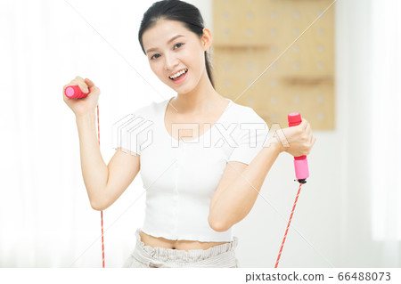Beautiful woman doing exercise at home 66488073
