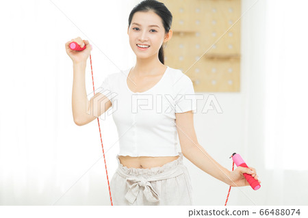 Beautiful woman doing exercise at home Beautiful woman doing exercise at home 66488074