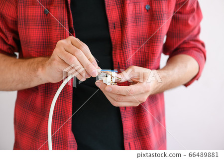 Electrician connect cables to extension plug cord 66489881