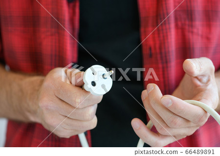 Hands hold white power strip close up Hands hold white power strip close up 66489891