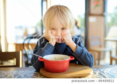 Little child sitting the table in cafe  66489922
