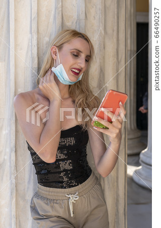 beautiful blond girl smiling with face mask after lock down reopening beautiful blond girl smiling with face mask after lock down reopening 66490257