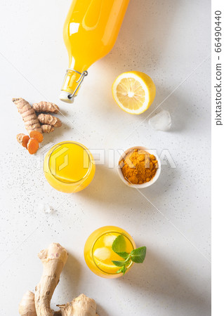 Jamu beverage of turmeric, ginger, lemon on white 66490440