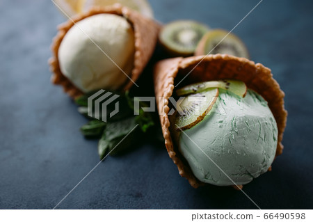 Waffle cones with exotic lemon and kiwi ice-cream 66490598