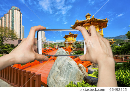 Girl taking pictures on mobile smart phone in 66492325