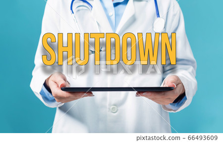 Shutdown theme with a doctor using a tablet pc Shutdown theme with a doctor using a tablet pc 66493609