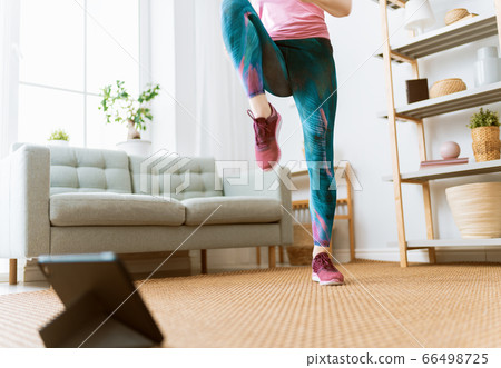 woman doing exercises at home woman doing exercises at home 66498725