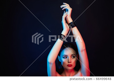 Girl in handcuffs. slave Beautiful young Woman in 66499648