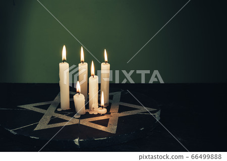 Six burning candles and the Star of David against Six burning candles and the Star of David against 66499888