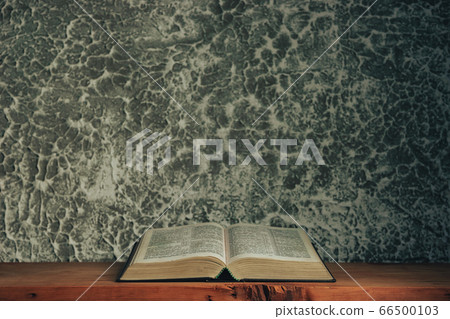 Open bible on a brown old wooden table. Beautiful 66500103