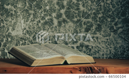 Open bible on a brown old wooden table. Beautiful Open bible on a brown old wooden table. Beautiful 66500104