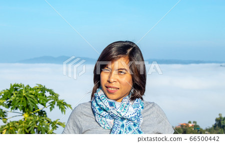 Portrait Asian woman background fog and the mountain. Portrait Asian woman background fog and the mountain. 66500442