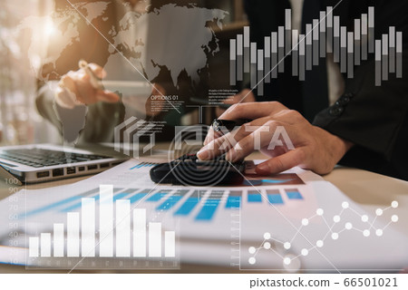 Businessmen team or financial data analysts working with tablets and laptop computers and data graphs together. Plan to analyzing projects in the office. 66501021