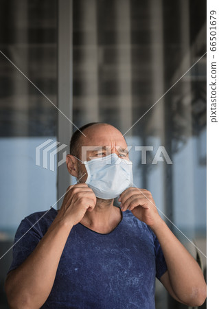 Man wearing facial disposable mask. Virus 66501679