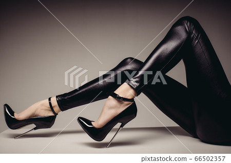 Slender female legs in spandex catsuit and a 66502357