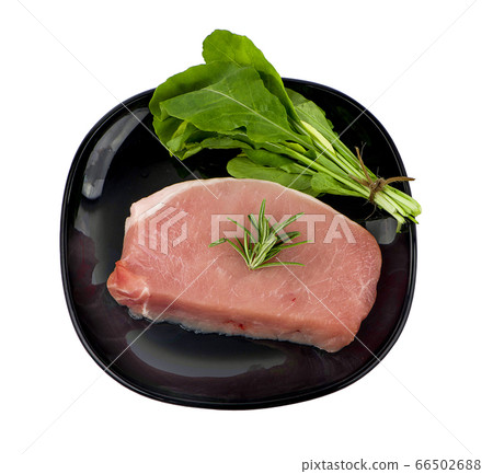 Pieces of raw pork steak in black plate with Pieces of raw pork steak in black plate with 66502688
