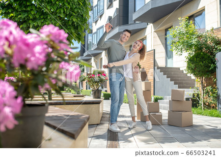 Smiling woman hugging her happy husband and they feeling awesome Smiling woman hugging her happy husband and they feeling awesome 66503241