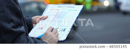 Man fills out insurance form on movement vehicle 66505145