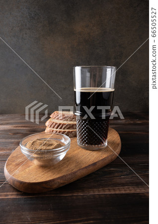 Homemade tradishional russian drink kvass with glass cup and bread on cutting board. Rustic style Homemade tradishional russian drink kvass with glass cup and bread on cutting board. Rustic style 66505527