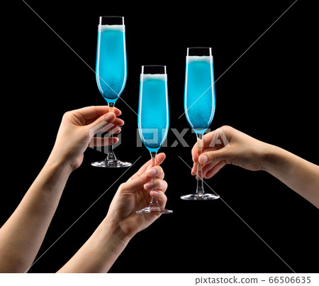 Set of hands holding glass of blue sparkling champagne isolated on black. 66506635