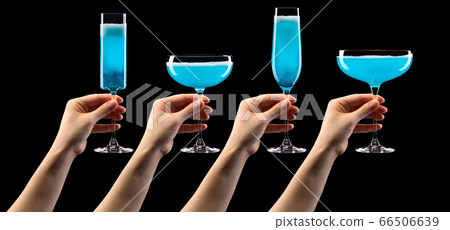 Set of hands holding glass of blue sparkling champagne isolated on black. Set of hands holding glass of blue sparkling champagne isolated on black. 66506639