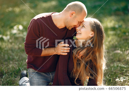 Beautiful couple spend time in a autumn park Beautiful couple spend time in a autumn park 66506875