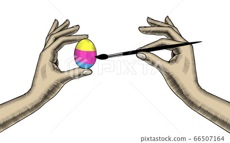 A woman coloring an egg for Easter. 66507164