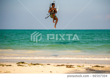 Young Attractive Muscular and Strong Athletic Black African Man Kite Surfing Instructor Teacher at the White Sand Beach 66507304