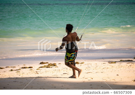 Young Attractive Muscular and Strong Athletic Black African Man Kite Surfing Instructor Teacher at the White Sand Beach 66507309
