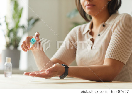 Mixed-Race Woman Sanitizing Hands Mixed-Race Woman Sanitizing Hands 66507607