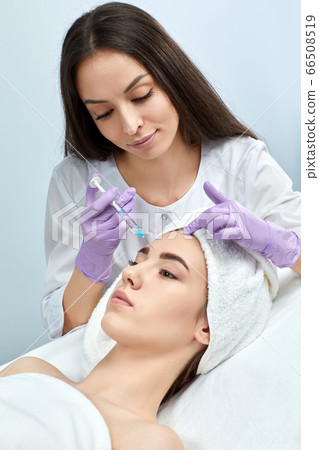 young woman getting beauty injections in salon young woman getting beauty injections in salon 66508519