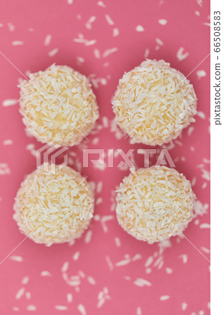 Candies covered by shredded coconut. Candies covered by shredded coconut. 66508583