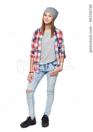 Smiling relaxed teen girl standing in full length Smiling relaxed teen girl standing in full length 66508786