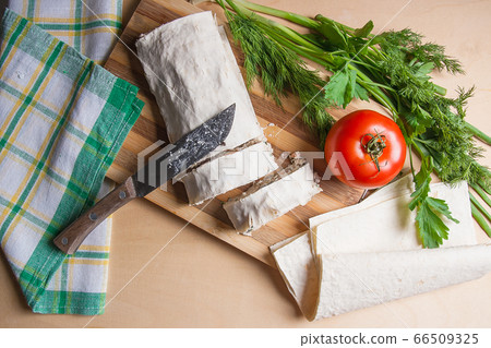 Pieces of cutted pita bread or lavash roll with 66509325