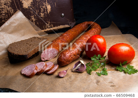 Slices of smoked sausage with spice, herbs and Slices of smoked sausage with spice, herbs and 66509468