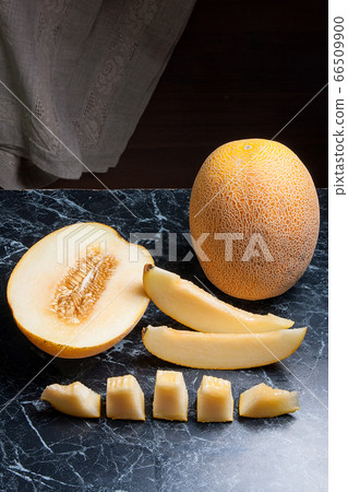 Whole, half and sliced honeydew melon fruit on 66509900