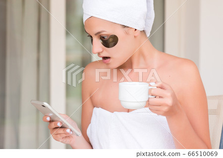Wrapped in towel after shower woman with eye Wrapped in towel after shower woman with eye 66510069