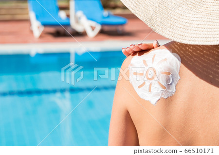 Gorgeous woman has a sun shaped sunblock on her Gorgeous woman has a sun shaped sunblock on her 66510171