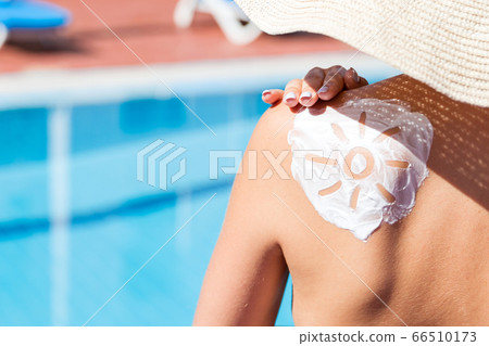 Gorgeous woman has a sun shaped sunblock on her Gorgeous woman has a sun shaped sunblock on her 66510173