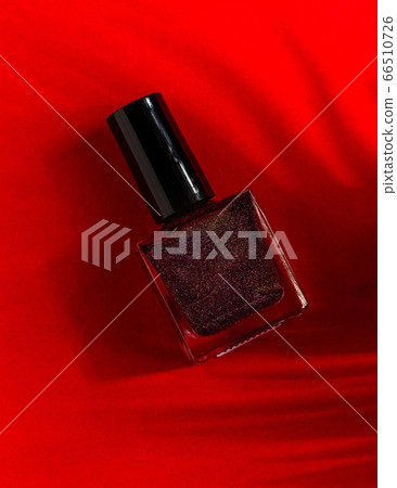 Red nail polish bottles on red background Red nail polish bottles on red background 66510726