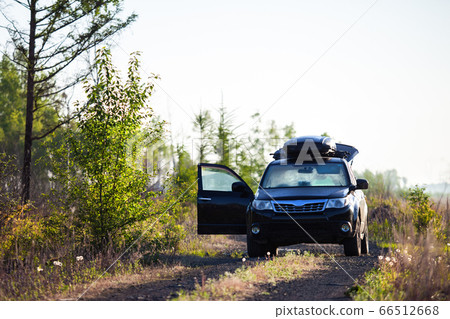 Subaru Forester with roof box at dirt road 66512668