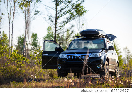 Subaru Forester with roof box at dirt road in the 66512677