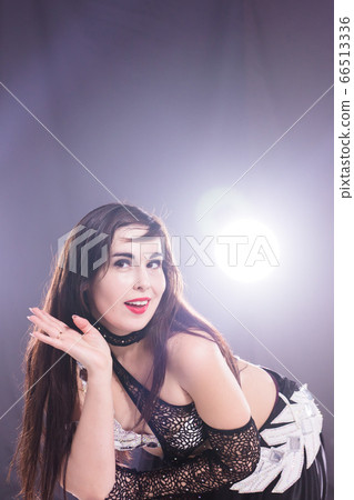Portrait of a woman in oriental costume performing belly dance. Tribal fusion dance concept. Portrait of a woman in oriental costume performing belly dance. Tribal fusion dance concept. 66513336