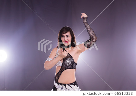 Young woman dancing in Tribal Fusion style. Belly dance on the stage. 66513338