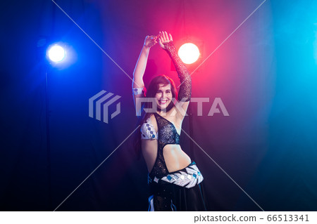 Spirituality dance. Beautiful sexy woman with luxury glossy eastern make-up dancing tribal fusion. Belly dance. 66513341