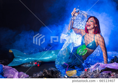 Fantasy stupid mermaid in deep ocean. Plastic water bottles and bags pollution on sea floor. Environmental problem. Fantasy stupid mermaid in deep ocean. Plastic water bottles and bags pollution on sea floor. Environmental problem. 66513407