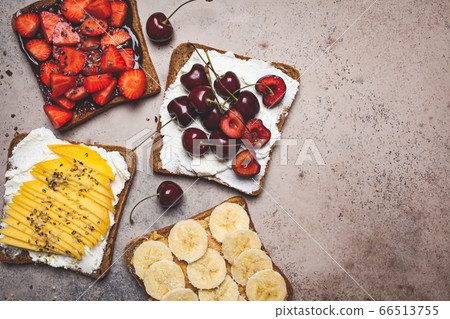 Different sweet fruit toasts with banana, mango, berries 66513755